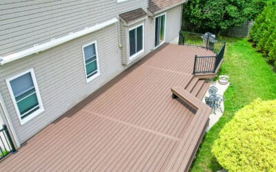 Extra-large new composite deck with custom bench seating and black aluminum rails in Brier, WA