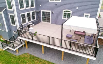 Large raised composite deck with striking black aluminum railing and custom staircase in Sammamish, WA