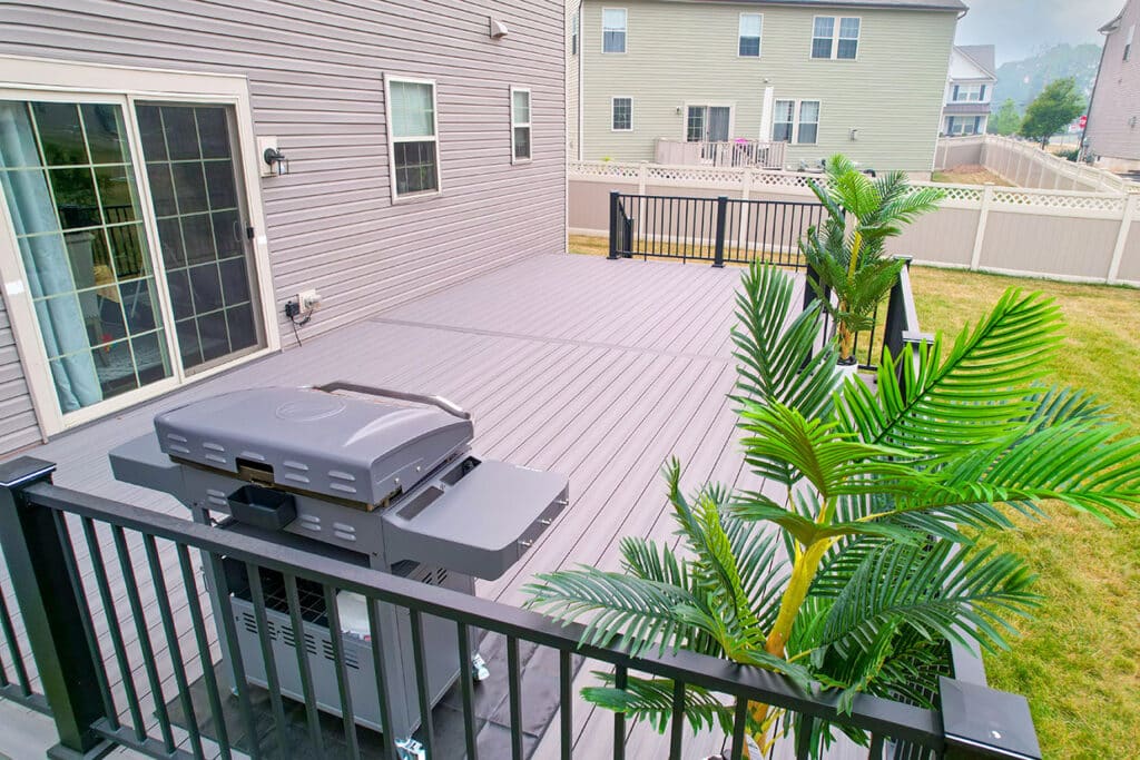 Rectangular Deck Resurfaced With Premium Composite Material And Contrasting Black Aluminum Railings And Custom Stairs In Tacoma, Wa