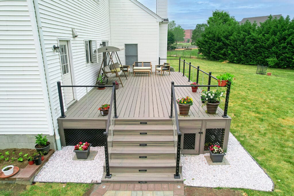 New Composite Deck With Dramatic Cable Railings And Contrasting Dark Lattice Skirting In University Place, Wa
