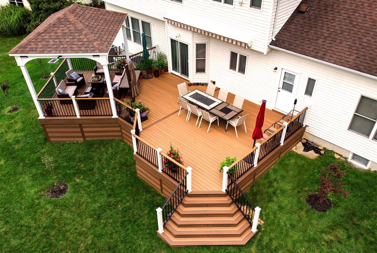 Aerial view of a multi-level deck makeover featuring distinct dining and gazebo zones.
