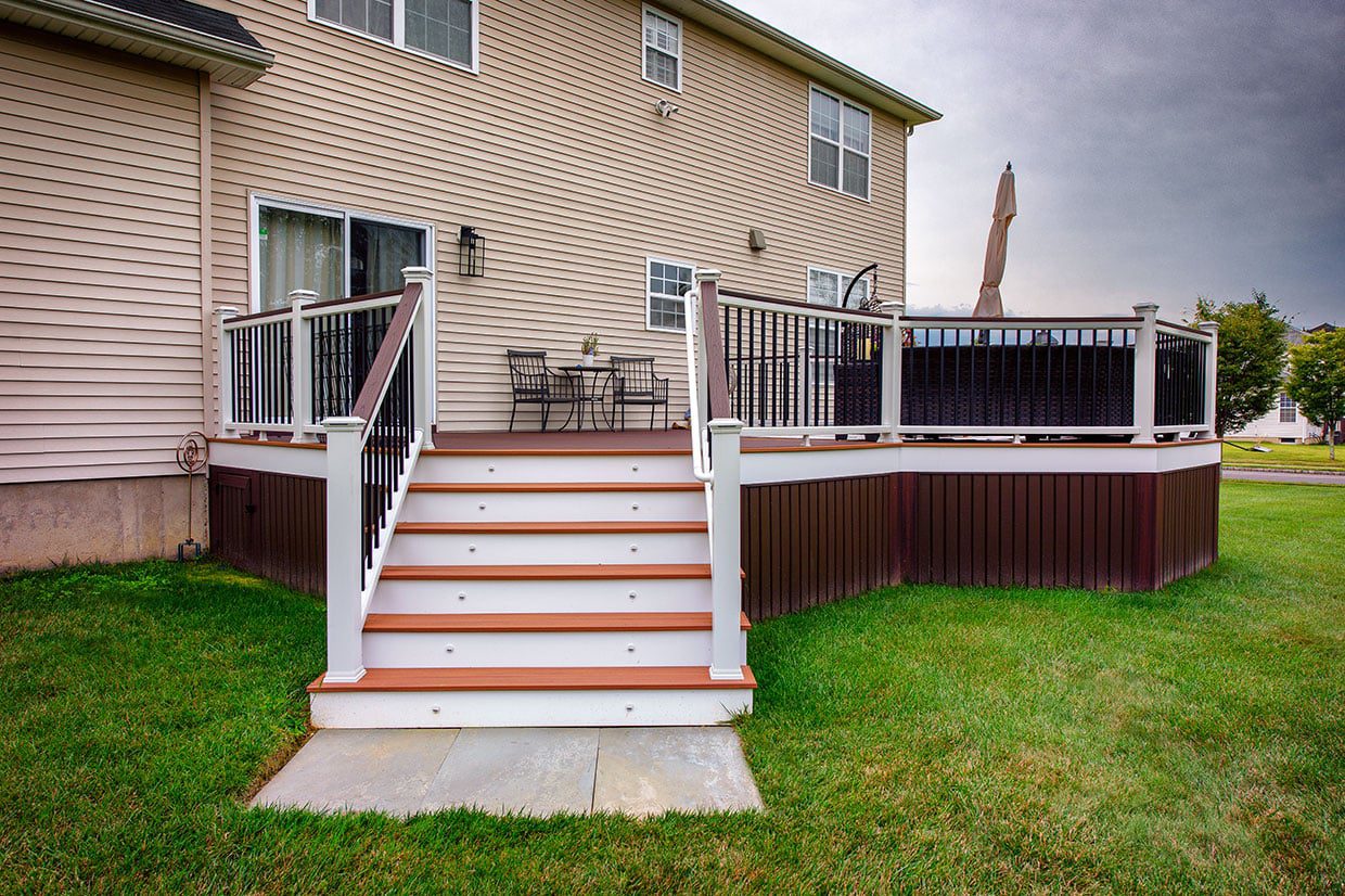 Wide stairs connecting the tiers of large multi-level decks with integrated riser lighting.
