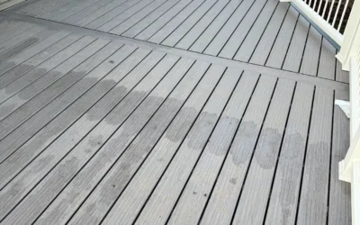 A restored deck with composite boards in gray tones and a white railing. Perfect for low-maintenance outdoor living. Restore decks.