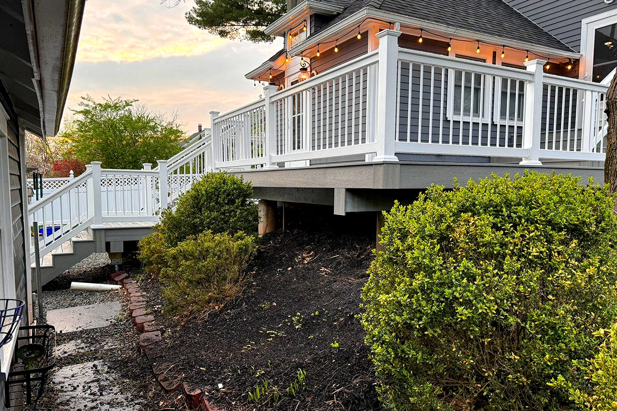 A stunning elevated deck with white railings and stairs, showcasing the exceptional craftsmanship of Best Deck Builders Near You.