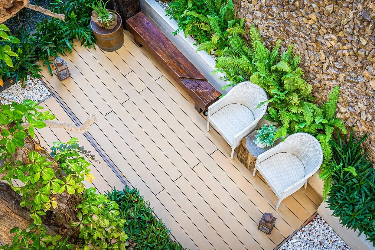 An aerial view of a beautifully arranged composite deck with outdoor seating and plants, perfect for Composite Deck Installation.