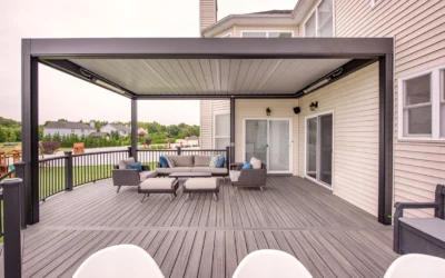 A spacious outdoor deck with a sleek louvered roof and modern seating arrangement, highlighting deck installation trends