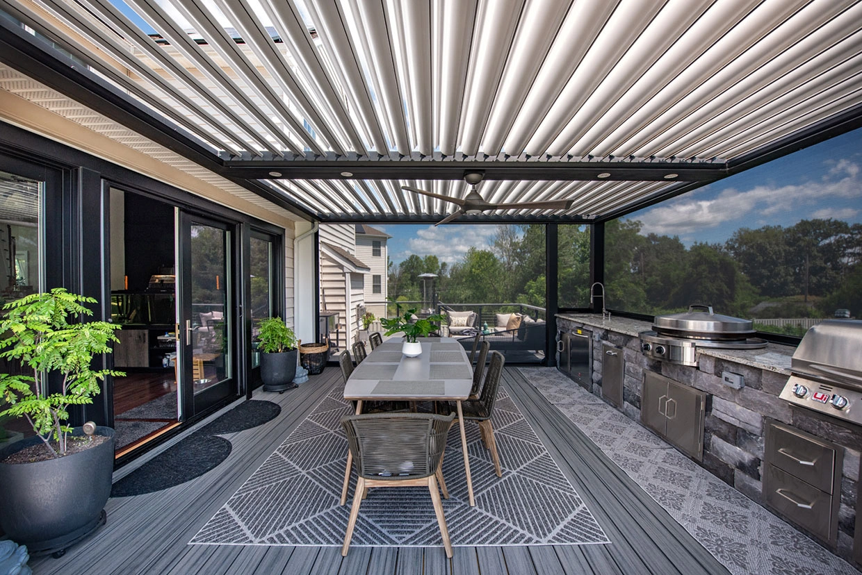 Louvered Roof Systems Seattle provides an elegant outdoor dining area with a built-in kitchen and adjustable shade.
