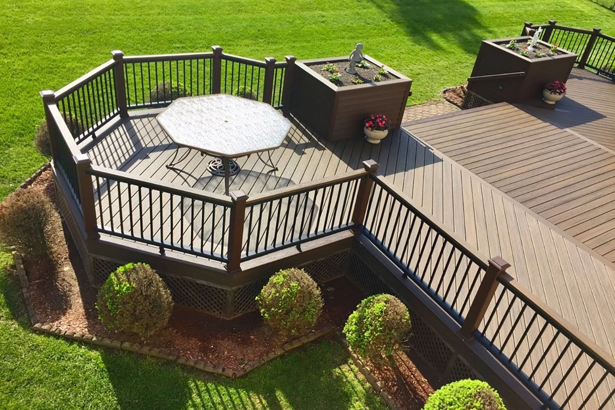 A spacious octagonal freestanding deck with a table and railing, demonstrating how to anchor a freestanding deck for stability and safety.