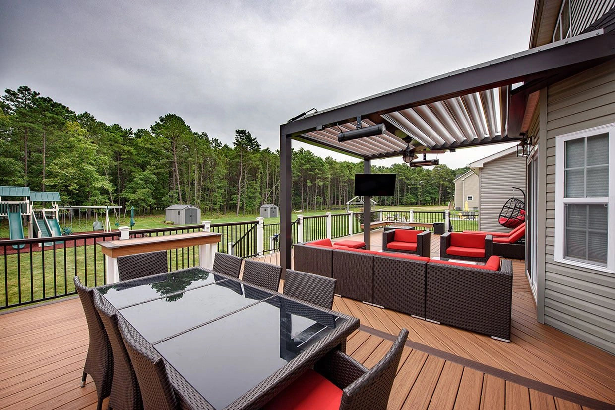 A freestanding deck with a pergola, dining, and seating area, showing how to anchor a freestanding deck for stability and comfort.