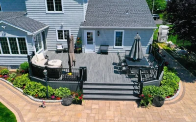 A deck layout featuring a dining set, seating area, and elegant landscaping with flowers and greenery.