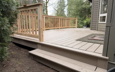 A new composite deck installation in Mill Creek WA features durable taupe planks and a classic wooden railing.