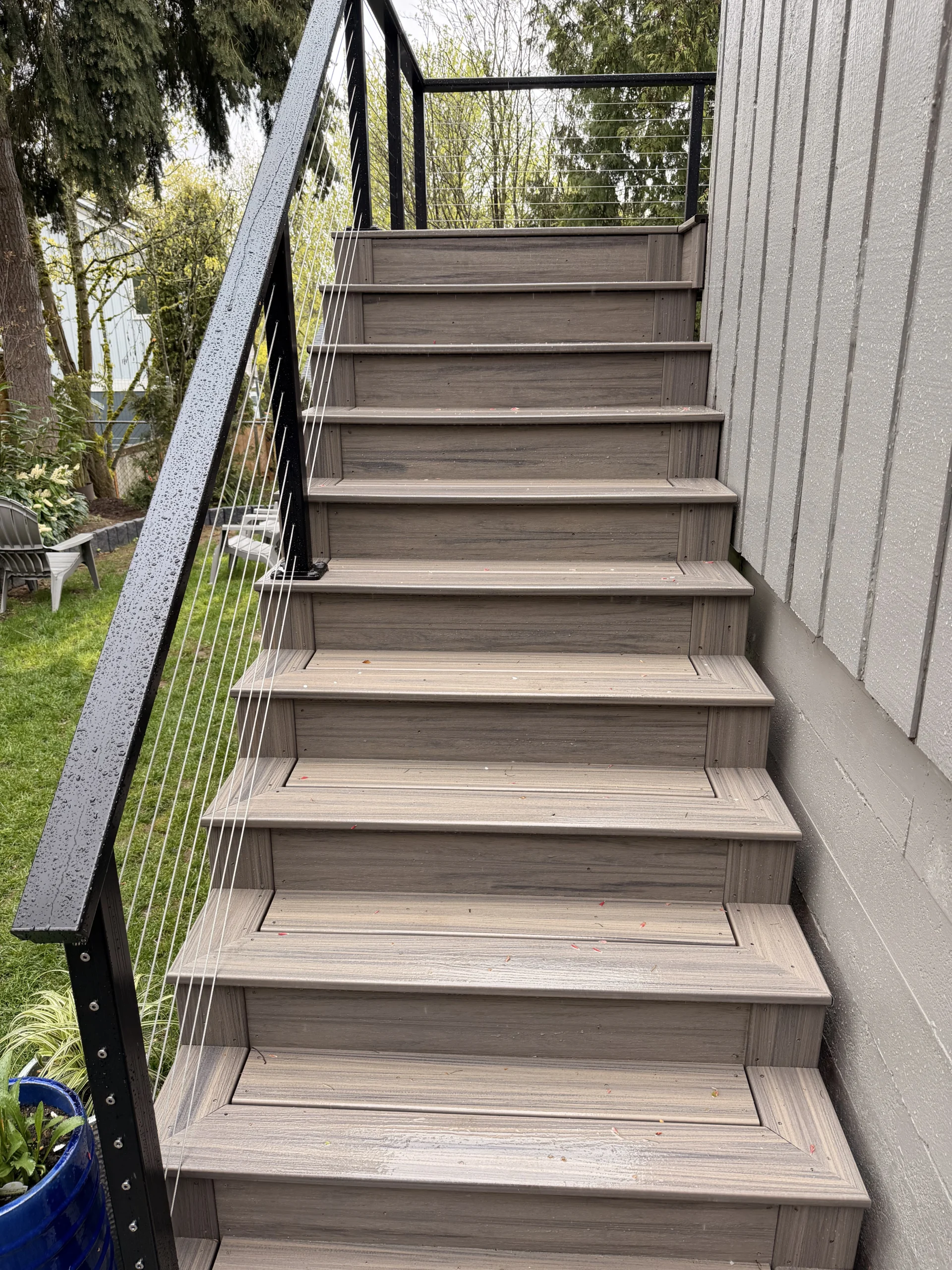 Composite outdoor stairs with cable railing built during a second story deck installation seattle wa.