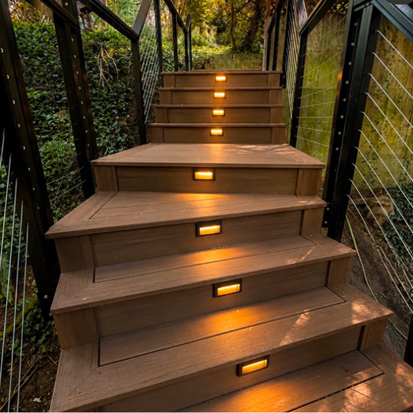 Illuminated Outdoor Composite Stairs With Step Lights And Cable Railings.
