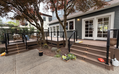 Multi-Level Composite Deck Featuring Black Cable Railings, Built-In Stair Lights, And A Mature Japanese Maple Tree.