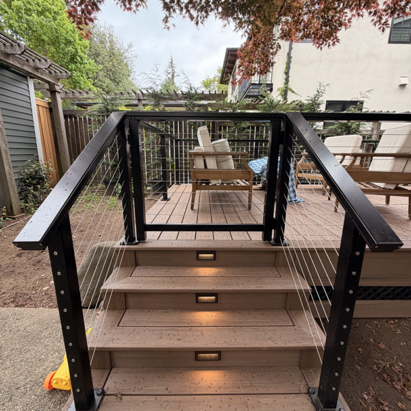 Composite Deck Steps With Integrated Led Riser Lights And Black Cable Handrails.