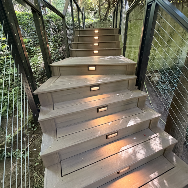 Custom Composite Stairs With Step Lights Winding Up A Hillside Garden.