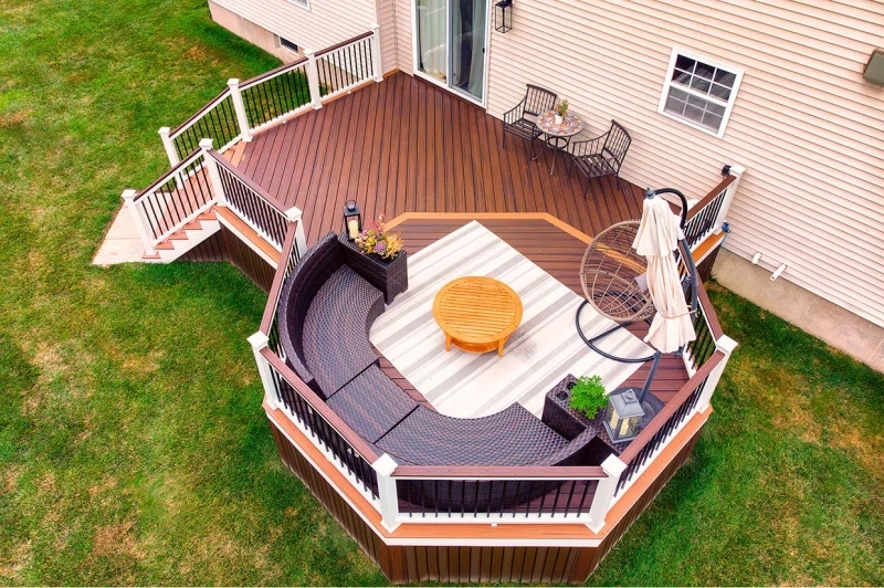 Custom Multi-Level Composite Deck Design by Olympic Decks Modern multi-level composite deck with curved outdoor furniture built by Olympic Decks.
