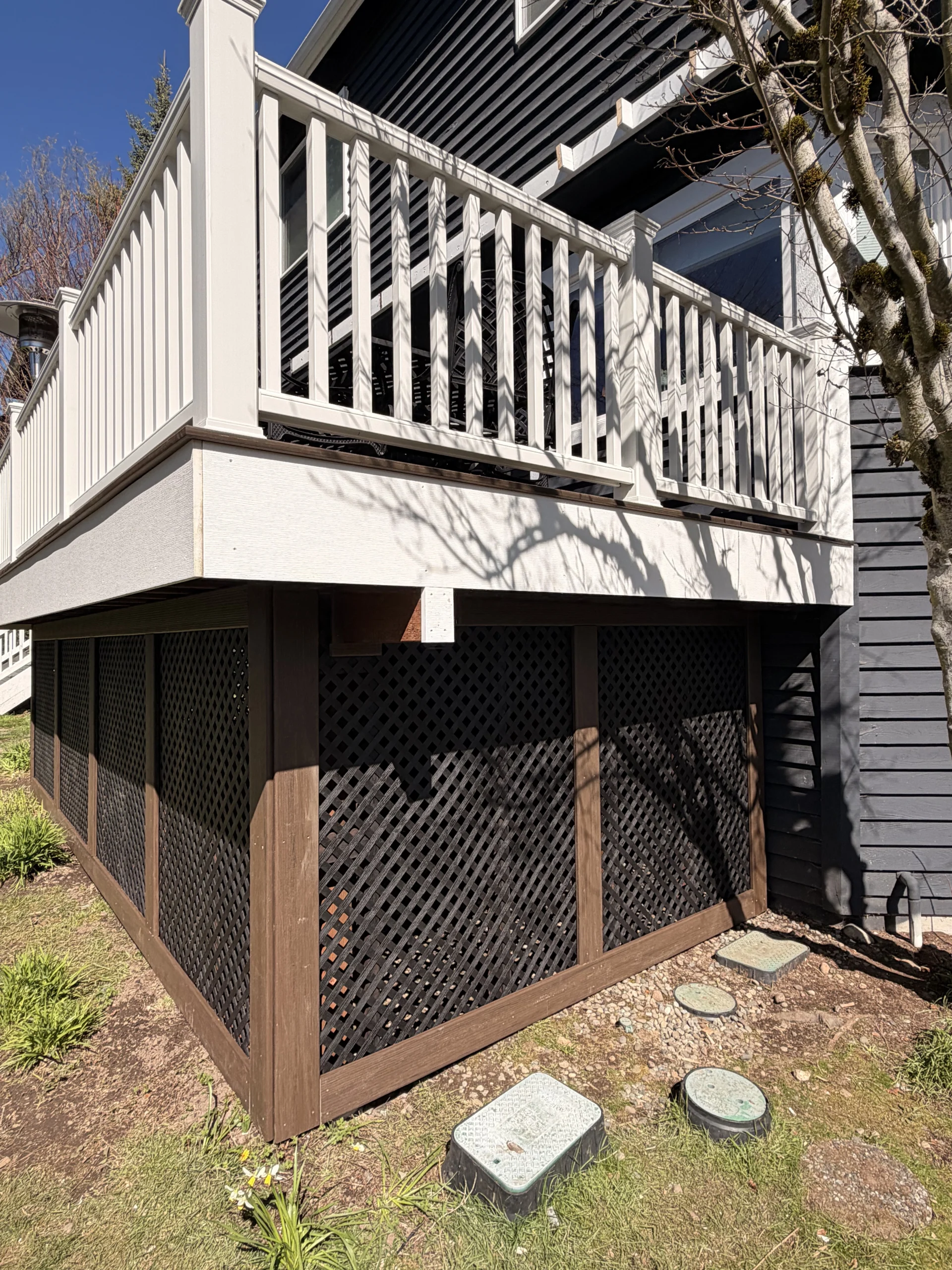 Corner view of dark lattice skirting built during a Trex Transcend deck replacement.