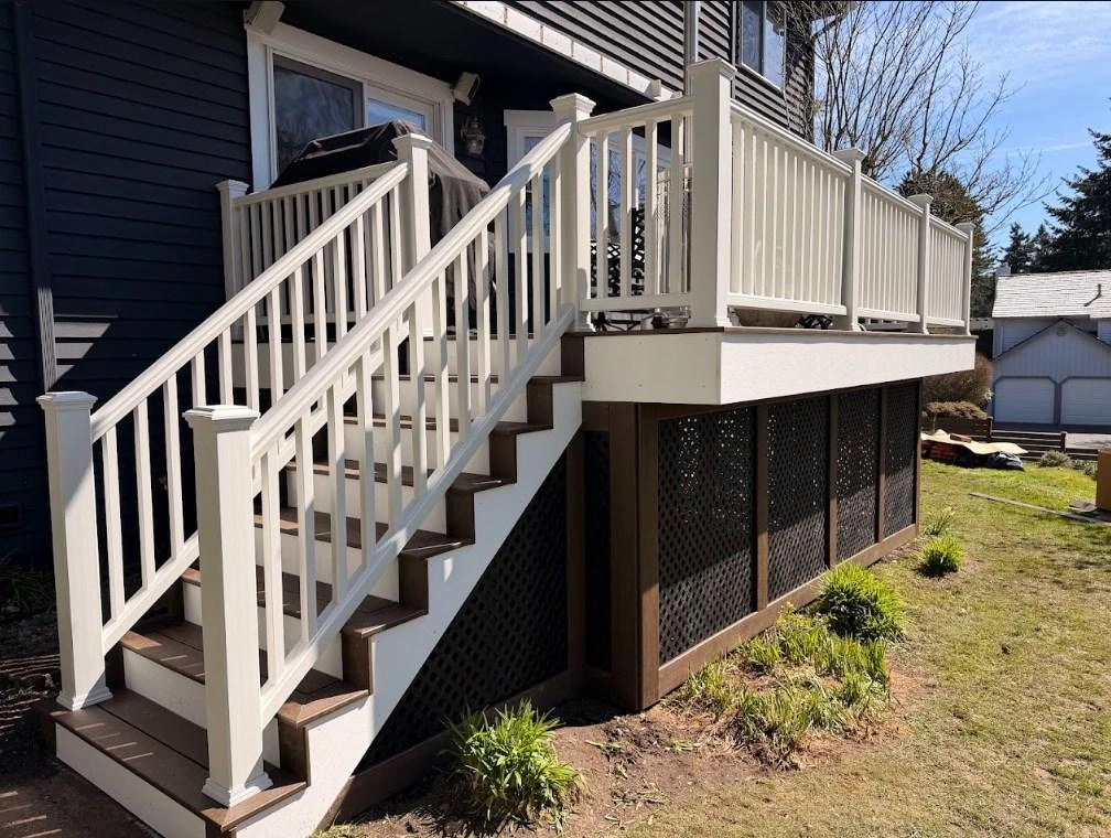 Modern Trex Transcend deck replacement with white railings and brown stairs.