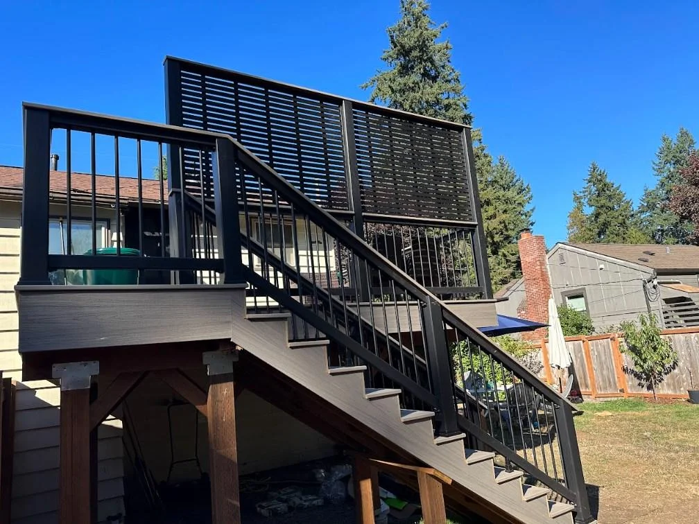 Elevated stairs and privacy screen in an AZEK Vintage deck replacement in Bellevue. Exterior Staircase And Slat Wall Built During An Azek Vintage Deck Replacement In Bellevue.