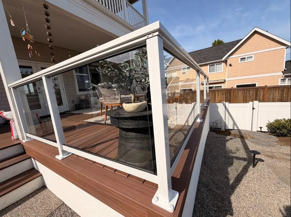 Transparent Glass Panel Railing Corner On A Ground-Level Azek Deck Replacement In Edmonds.