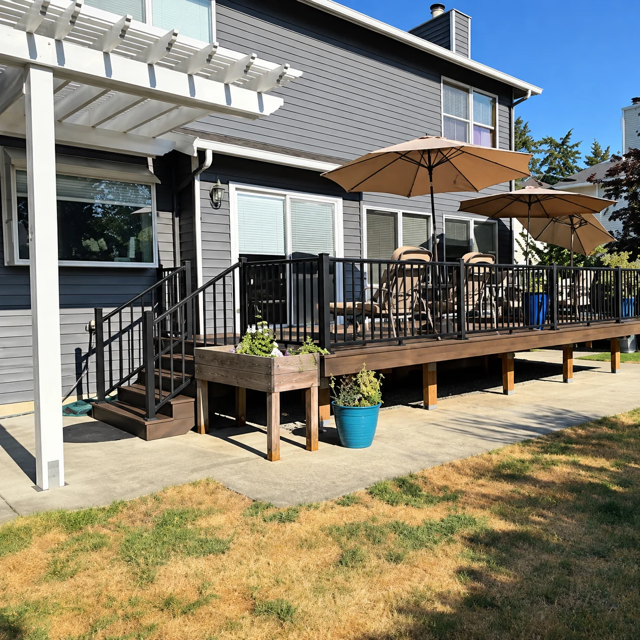 Modern composite outdoor patio deck with black railings built as a Trex Transcend deck replacement in Bothell. Completed 350-Square-Foot Trex Transcend Deck Replacement With Cable Railing And Stairs In Bothell, Wa